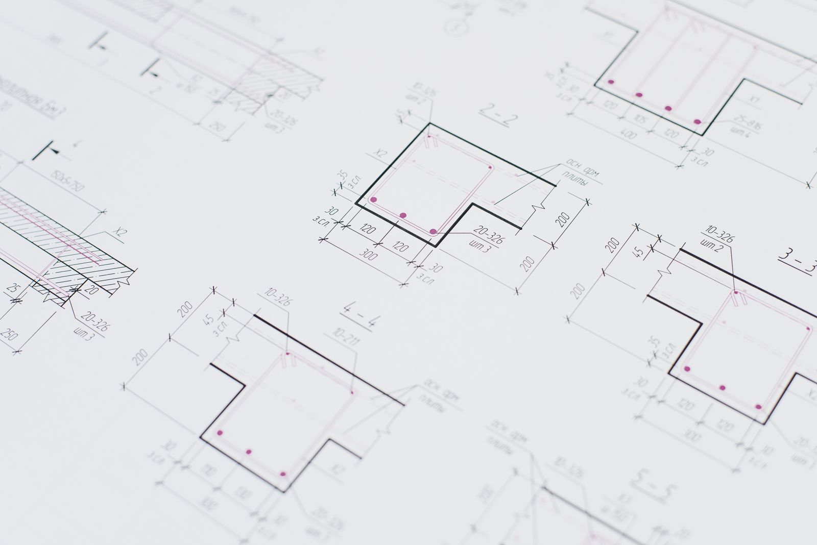 High-resolution close-up of detailed architectural blueprints showcasing precision design layouts.
